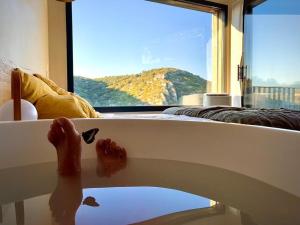 a person standing on a bed looking out a window at Metafort in Méthamis +32 photos