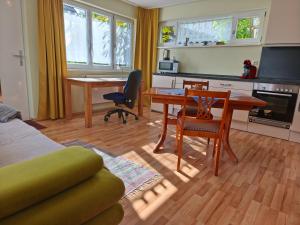 a living room with a desk and a table and chairs at fewolehr in Ulm