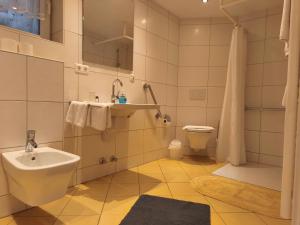 a bathroom with a sink and a toilet at fewolehr in Ulm +64 photos
