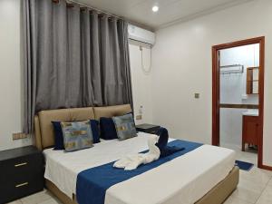 a bedroom with a bed with a stuffed animal on it at Alice 3-bedroom luxury apartment in Nadi