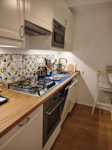a kitchen with a stove and a counter top at Casa vista Faraglioni Capri in Capri