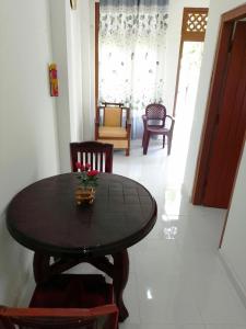 a dining room table and chairs in a room at Tropical Suites - Airport Transit Residence in Negombo