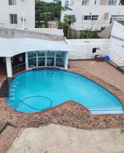 a large swimming pool in front of a building at Premium Suites in Maputo