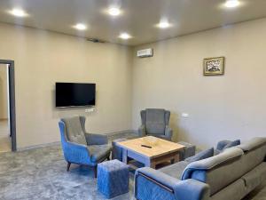 a waiting room with a couch and chairs and a table at Mughni Family House in Ashtarak