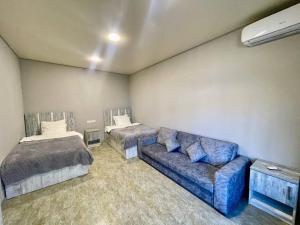 a living room with two beds and a couch at Mughni Family House in Ashtarak