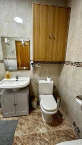 a bathroom with a toilet and a sink at Amanecer zen in Argés +23 photos