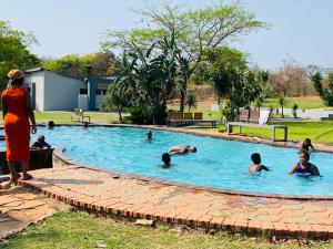 a group of people swimming in a swimming pool at Kingsgate Nandoni Dam, Thohoyandou in Thohoyandou
