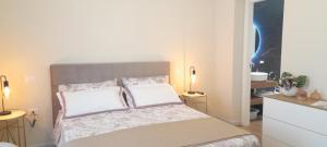 a small bedroom with a bed with two pillows at Terra Sinus Luxury apartment in Terrasini