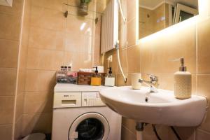 a bathroom with a sink and a washing machine at BALLET MAISON in the heart of the city in Alexandroupoli +79 photos