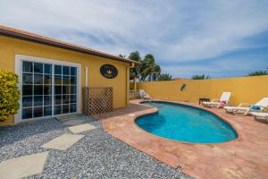 a swimming pool in front of a house at Casa de Reyes in Palm-Eagle Beach