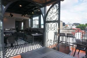 a restaurant with a balcony with tables and chairs at Jade Boutique Hotel in Hanoi