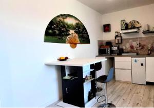 a kitchen with a counter and a table in a room at Maison L'Aloé in Nice