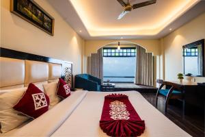 a bedroom with a large bed with red pillows at Snow Valley Resorts Dalhousie in Dalhousie