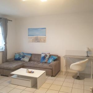 a living room with a couch and a table at Ferienwohnung Stefanie am Frankenbach in Bad Breisig