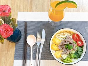 a plate of food on a table with a bowl of noodles at Hanoi Family Homestay in Hanoi