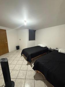 a room with two beds in a room with at Casa en segunda planta in Hidalgo del Parral
