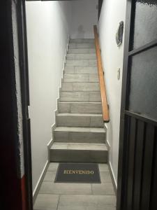 a staircase with a sign on the floor next to a door at Casa en segunda planta in Hidalgo del Parral