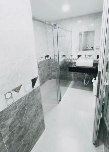 a bathroom with a shower and a sink at Kim's House in Ho Chi Minh City