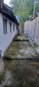 an alley between a house and a fence at Dumaguete Divers in Dauin
