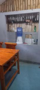 a kitchen with a table and a blue bowl on a shelf at Dumaguete Divers in Dauin