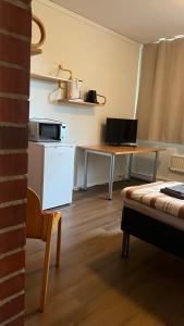 a kitchen with a table and a desk with a laptop at Vanha Koulu in Suolahti +34 photos