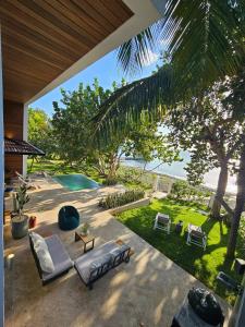 an outdoor living room with a view of the ocean at Bayshore 76 Beachfront Villa Palmar de ocoa in Palmar de Ocoa