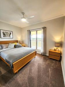 a bedroom with a large bed and a window at Willow Lodge 