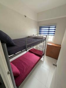 a bedroom with two bunk beds and a window at JLC Crib in Naga