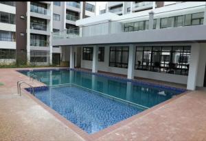 a swimming pool in front of a building at Roly Studio Apartment Near Jkia & Sgr with Swimming pool & Gym in Nairobi