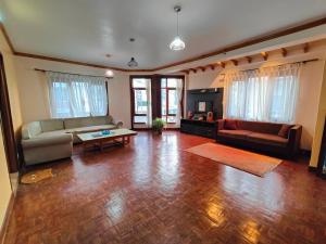 a living room with a couch and a table at Peace Home Apartment Swayambhu in Kathmandu