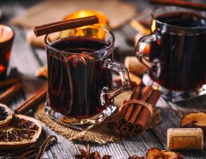a cup of coffee on a wooden table with cinnamon at Cosy studio in Serre Chevalier in Saint-Chaffrey