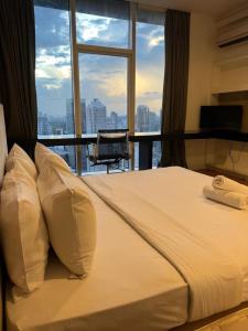 Una cama grande en una habitación con una ventana grande. en Platinum Kuala Lumpur five City, en Kuala Lumpur 77 fotos más