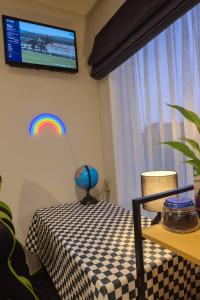 a room with a table with a rainbow on the wall at Queen Bed with Private Bath TV kitchen access and one Parking in Rolleston