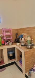 a kitchen with a counter with many items on it at Paul's House in Nungwi