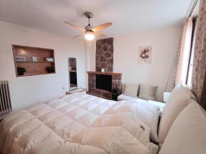 a bedroom with a large bed and a fireplace at Delphi Sunset Apartment in Delfoi