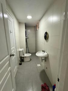 a small bathroom with a toilet and a sink at Ayaan Quintet Evergreen with FIFA & Private Parking in Tanah Rata +8 photos