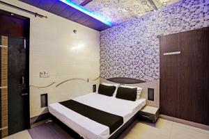 Postel nebo postele na pokoji v ubytování Hotel O Ginni