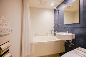 a bathroom with a sink and a bath tub at 中野ワールドホテル in Tokyo +159 photos