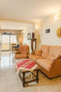 a living room with two couches and a table at Aba Jacuzzi in Tirana