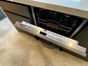 an oven with its door open in a kitchen at Brand-New Large house Castlebane Drive in Auckland +60 photos