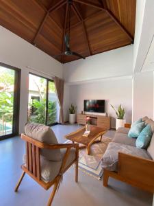 a living room with a couch and a table at Ulusunny Bingin in Bingin Beach