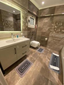a bathroom with a sink and a toilet at Heliopolis Ultra Luxury Panoramic Apt Near Cairo Airport in Cairo +65 photos