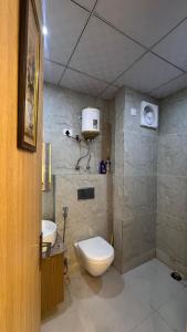 un baño con inodoro y lavabo en Visitor Stop, en Greater Noida