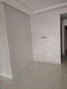 a room with a white wall with a sign on it at Riad Salam Tangier in Tangier