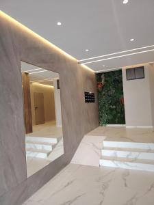 a lobby with stairs and a wall with a mirror at Riad Salam Tangier in Tangier