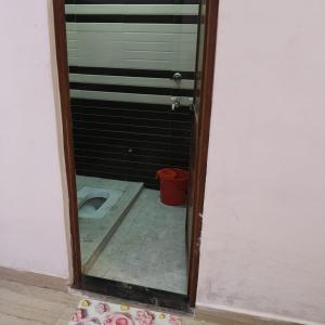 a bathroom with a toilet in a room at SHREE MANDAP HOTEl 