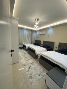 a hotel room with three beds in a room at Heliopolis Ultra Luxury Panoramic Apt Near Cairo Airport in Cairo