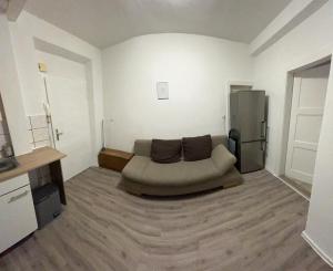 a living room with a couch and a refrigerator at PaNi 2 in Altdorf bei Nuernberg