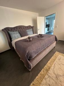 a bedroom with a large bed with a brown comforter at V.I.P Appartement in Böttstein