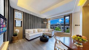 a living room with a white couch and a table at MuYun Villa Lijiang in Lijiang